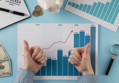 top-view-business-items-with-growth-chart-hands-giving-thumbs-up-1