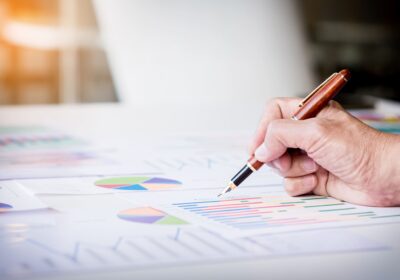 working-process-startup-businessman-working-wood-table-with-new-finance-project-modern-notebook-table-pen-holding-hand-1